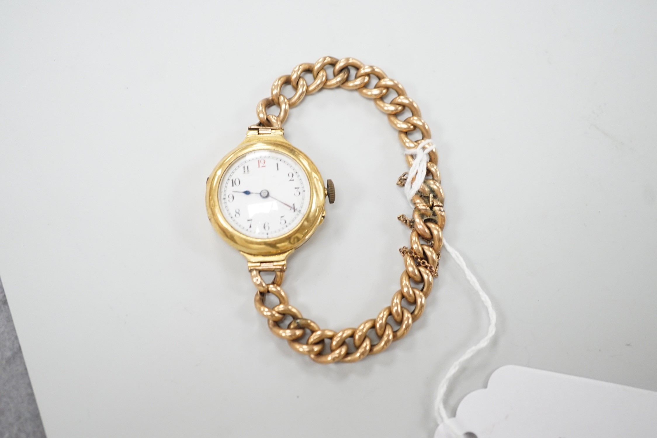 An early 20th century 18ct gold manual wind wrist watch, with Arabic dial, case diameter 27mm, on a yellow metal (stamped 15) curblink bracelet